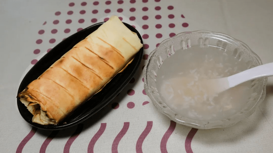 铺上烤的软糯饵块,加入各种佐料再浇上稀豆粉卷起来就可以开吃啦必吃